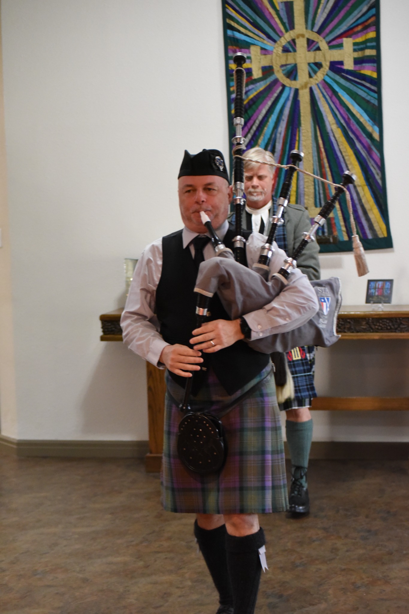 Richard Kean playing bagpipes during a wedding ceremony