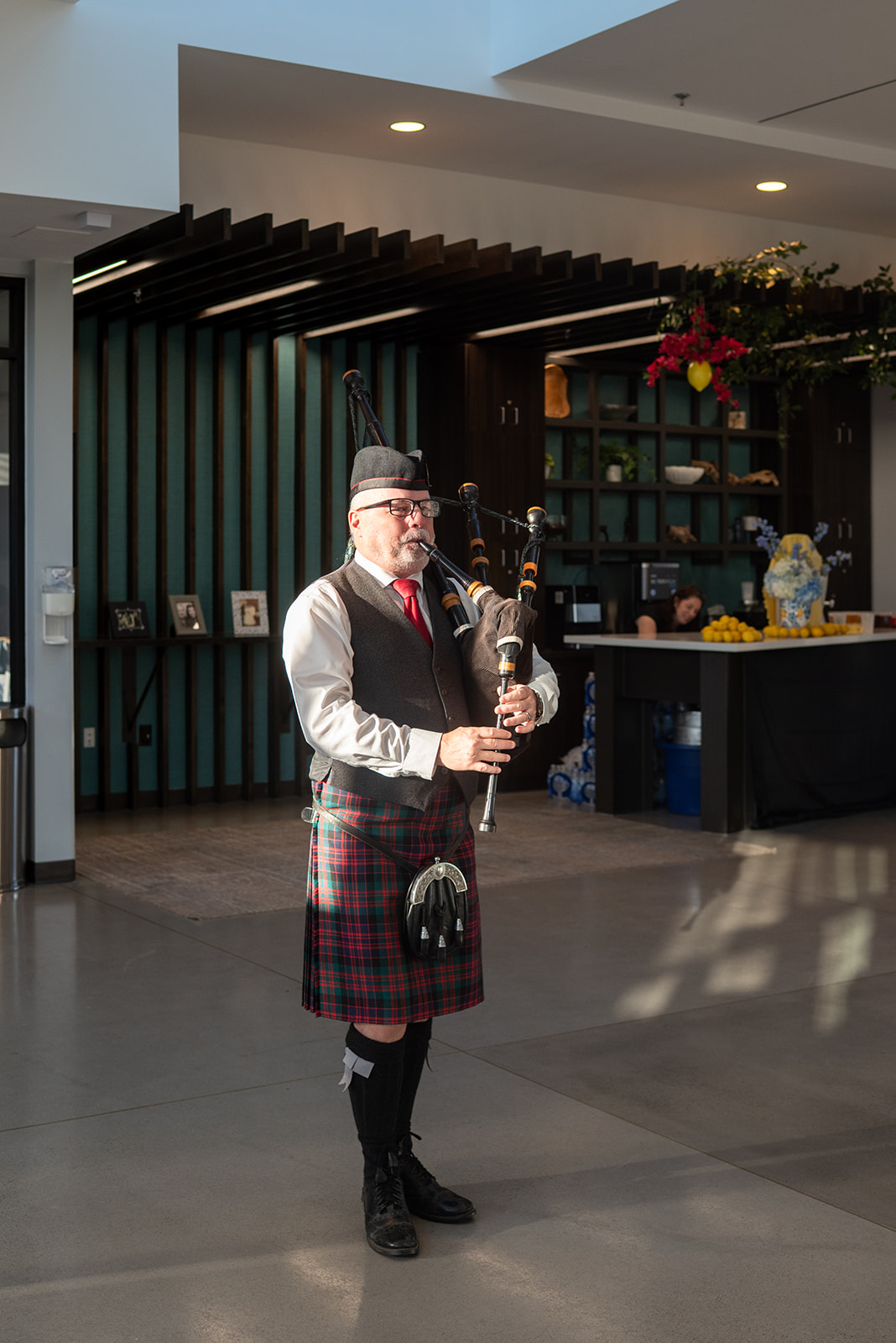 Richard Kean performing bagpipes indoors at a wedding