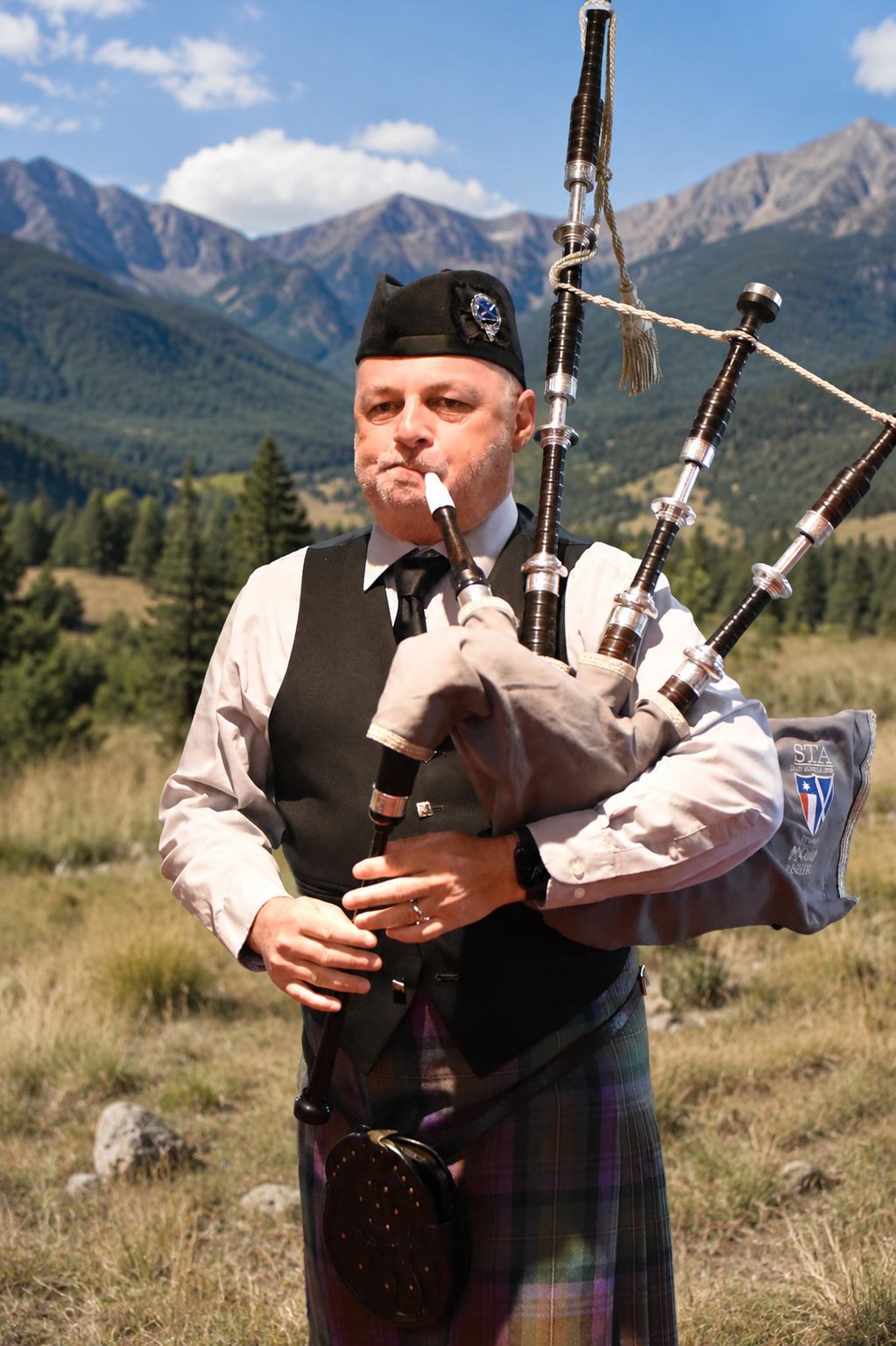 Richard Kean playing bagpipes in the Colorado mountains